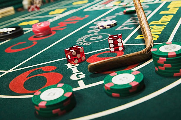 Live dealer rolling three dice in transparent cage on Lightning Dice table